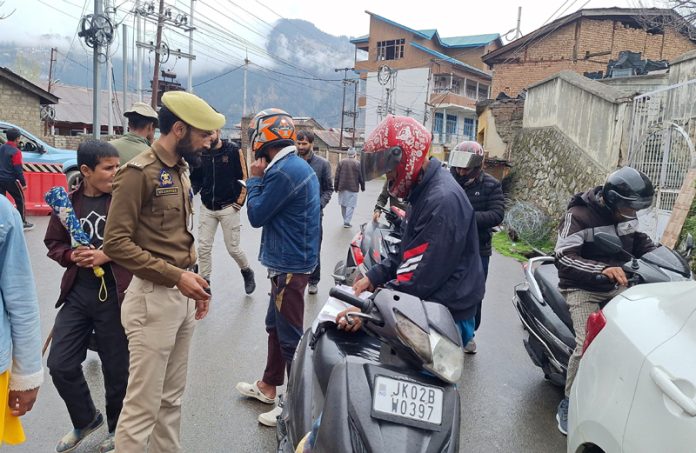 Cops inspect vehicles for violations in Bhaderwah on Friday.