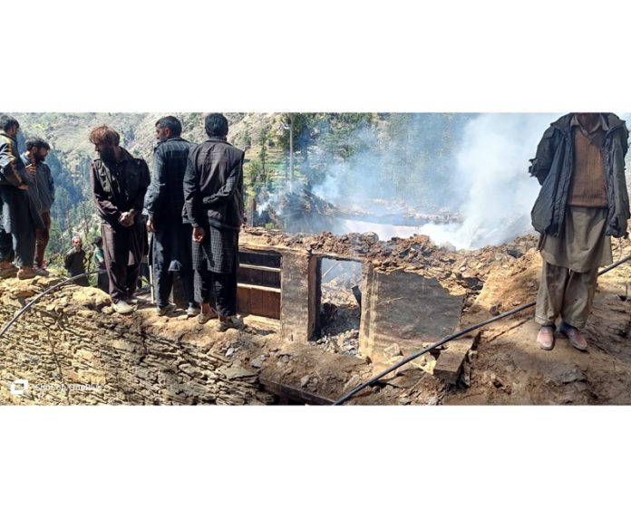 A residential house damaged in fire incident in Kishtwar on Saturday. - Excelsior/Tilak Raj