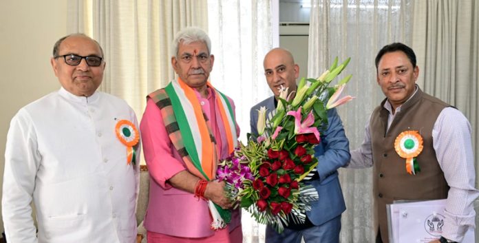 Ärvind Mattoo presenting bouquet to LG Manoj Sinha.