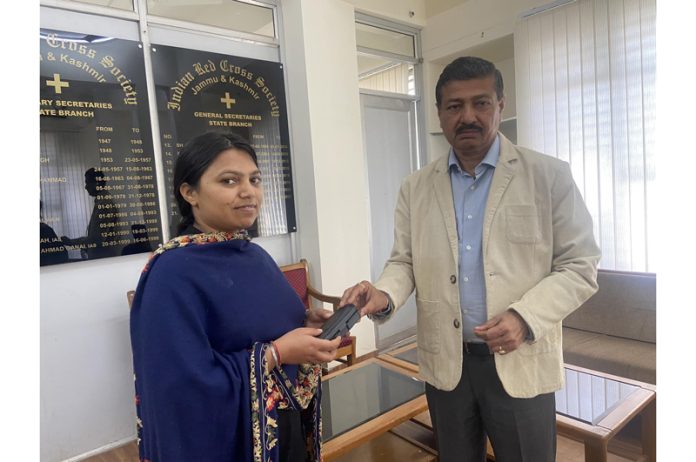 An official presenting spectacles to a needy girl at Red Cross Bhawan, Kachi Chawni Jammu. An official presenting spectacles to a needy girl at Red Cross Bhawan, Kachi Chawni Jammu.
