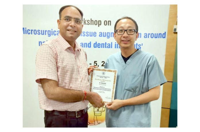 IDA Jammu president Dr Gautam Sharma receiving a certificate from an expert.