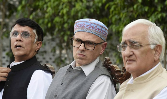 Congress leaders Pawan Khera and Salman Khurshid with National Conference leader Omar Abdullah addressing a press conference in New Delhi on Monday. (UNI)