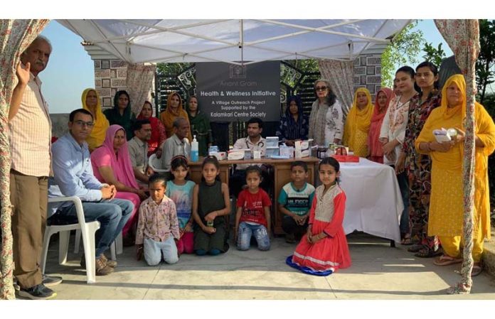 A doctor and villagers during a health checkup camp at Panjgrain in Jammu.