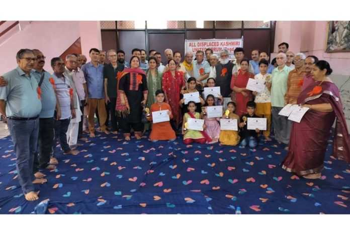 Children who received trophies and certificates during a socio-cultural programme posing with organisers of the function at Durga Nagar on Sunday. Children who received trophies and certificates during a socio-cultural programme posing with organisers of the function at Durga Nagar on Sunday.