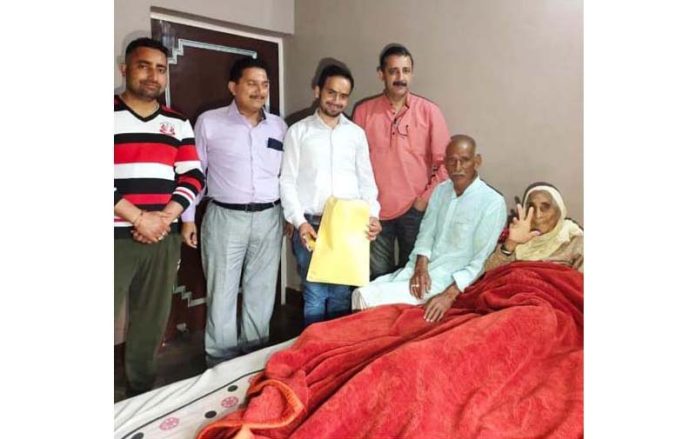 Election officials collect postal ballots from elderly people in Udhampur on Monday.