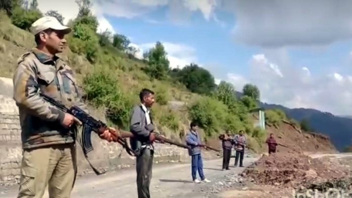 Cops and VDGs stand guard on a road in Basantgarh on Monday. -Excelsior/K Kumar Cops and VDGs stand guard on a road in Basantgarh on Monday. -Excelsior/K Kumar