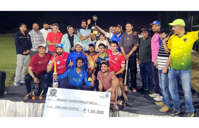 Dignitaries posing along with winning team and trophy.