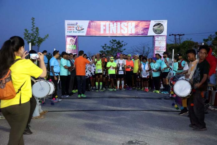 Runners preparing for a race during SMVD Katra Half Marathon at Katra on Sunday.