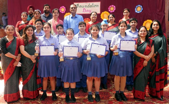 Students displaying certificates while posing with teaching faculty. Students displaying certificates while posing with teaching faculty.