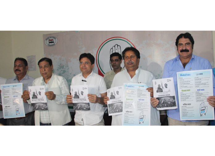 AICC Secy Manoj Yadav and others releasing Cong ‘Nyaye Pattar’ during press conference in Jammu on Friday. -Excelsior/Rakesh
