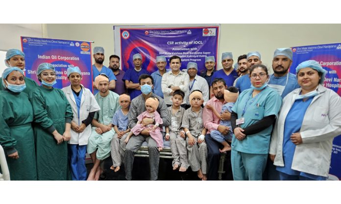A team of doctors and OT technicians of SMVD Narayana Hospital posing with children on whom CI surgeries were performed.
