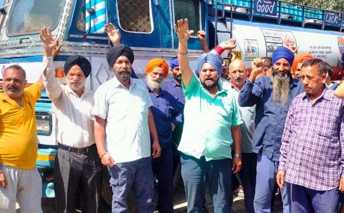 Oil tankers drivers and cleaners staging protest at Narwal Depot in Jammu on Sunday. -Excelsior/Rakesh