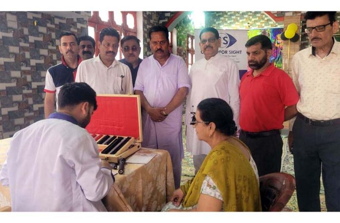 A doctor checking the patient during a free eye camp organised in Jammu on Sunday.