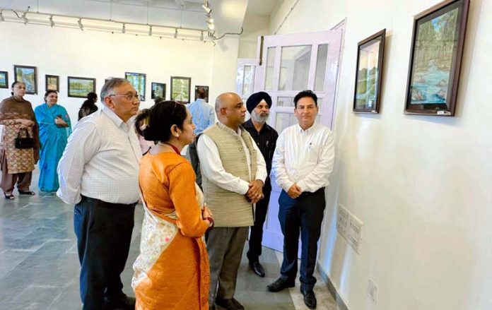 Dignitaries watching paintings during an exhibition at Kala Kendra on Monday.