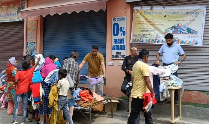 Members of NSG Trust distributing clothes during a camp in Jammu on Friday. Members of NSG Trust distributing clothes during a camp in Jammu on Friday.