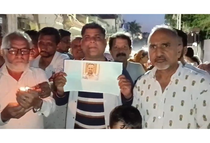 Residents of Resham Ghar Colony taking out a candle light march on Sunday. Residents of Resham Ghar Colony taking out a candle light march on Sunday.