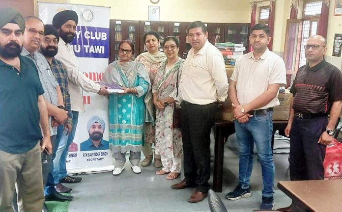 Members of Rotary Club Jammu Tawi presenting books to staff members of Government High Secondary School Nagrota.