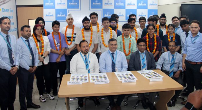Parmeshwar Jha, Regional Director AESL along with the students excelled in the JEE Main Exams, in Jammu on Thursday. -Excelsior/Rakesh Parmeshwar Jha, Regional Director AESL along with the students excelled in the JEE Main Exams, in Jammu on Thursday. -Excelsior/Rakesh