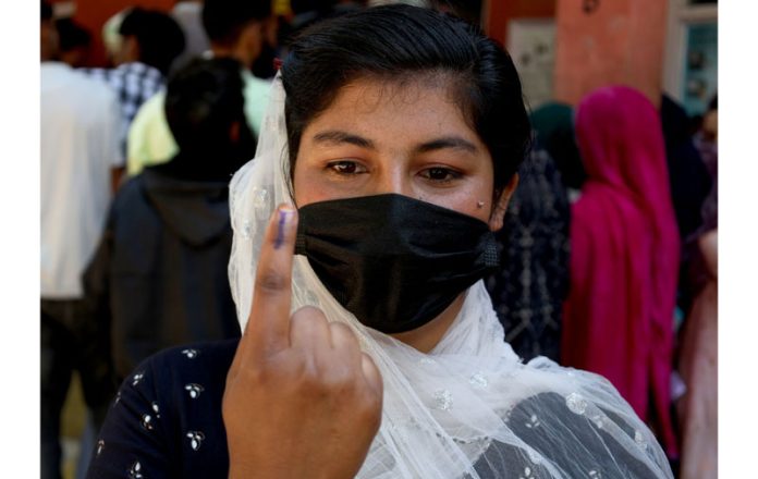 A first-time voter proudly displays her inked finger after casting her vote. -Excelsior/Shakeel