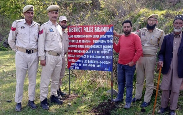 Police attaching property of a terror handler in Uri. Police attaching property of a terror handler in Uri.