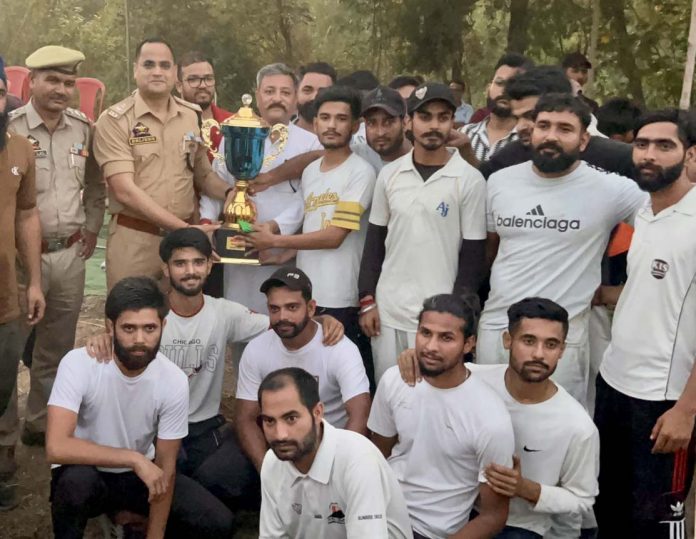 Police officer presenting trophy to winning team on Tuesday. Police officer presenting trophy to winning team on Tuesday.