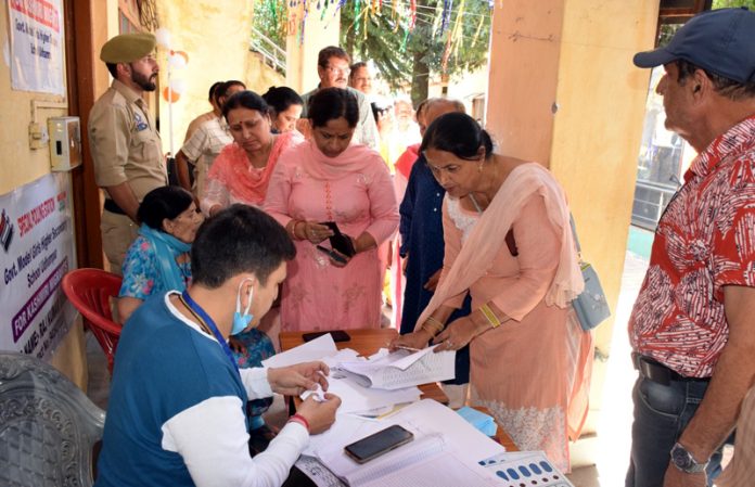 Migrant voters search their names in the list at Udhampur polling station. -Excelsior/K Kumar