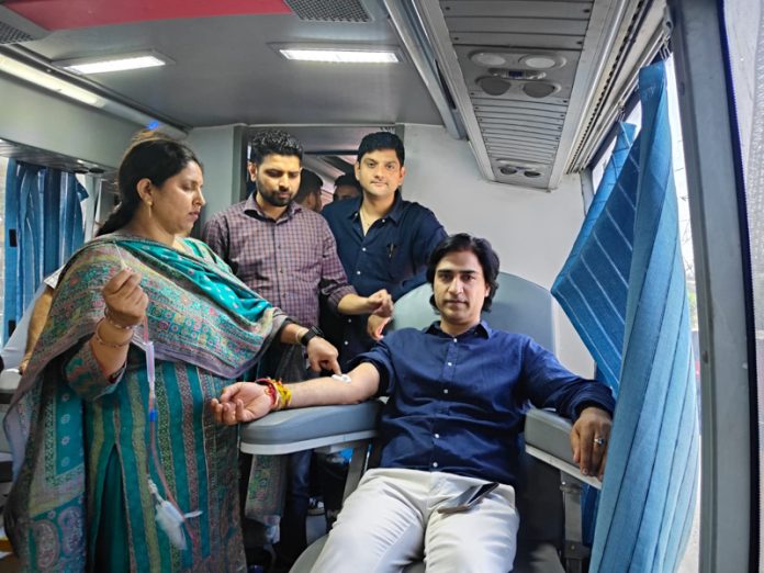 A volunteer donating blood during a camp.