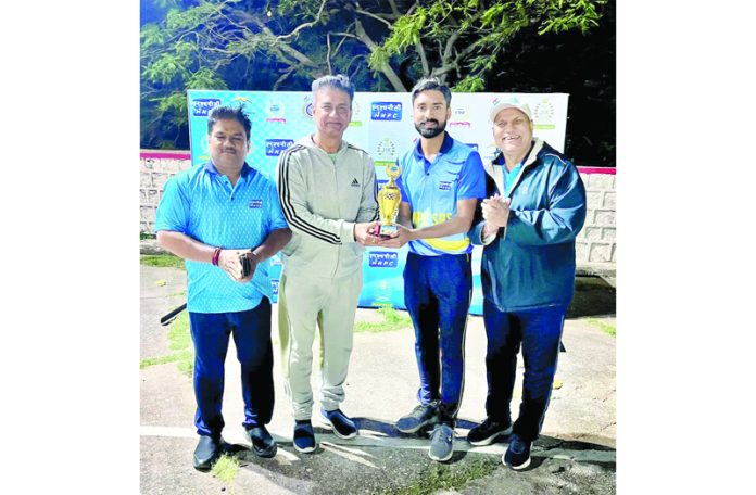 Dignitary presenting man of the match trophy to player.