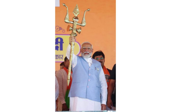 Prime Minister Narendra Modi holds a trident at a public meeting in Uttar Pradesh on Friday. (UNI) Prime Minister Narendra Modi holds a trident at a public meeting in Uttar Pradesh on Friday. (UNI)