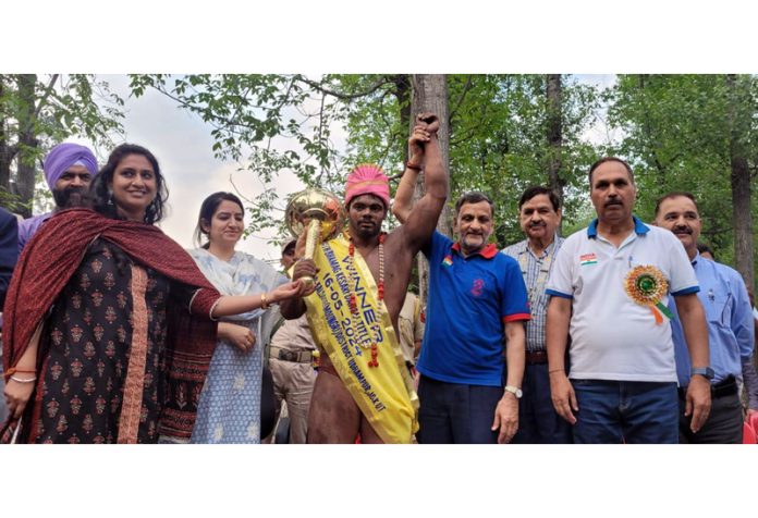 Deputy Commissioner Udhampur, Saloni  Rai and Dangal Management Committee posing along with winner wrestler  at Moungri.