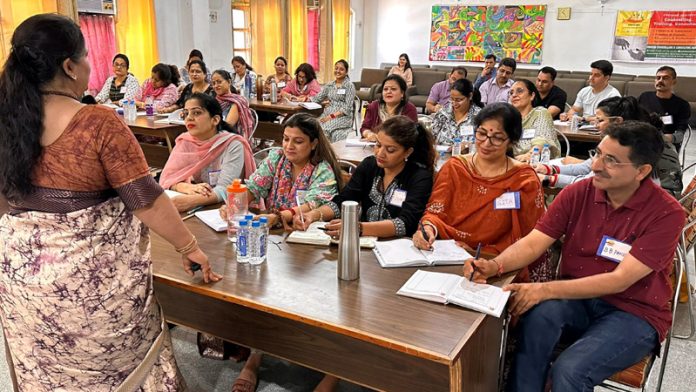 Resource person interacting with teachers during a training programme. Resource person interacting with teachers during a training programme.
