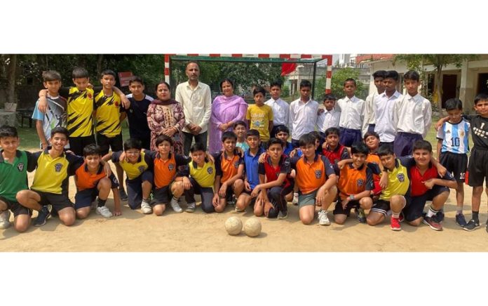 Players posing for group photograph along with teaching staff.