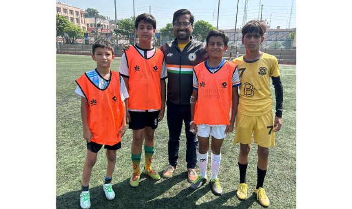 Sudeva Delhi Football Club founder posing along with aspiring footballers.