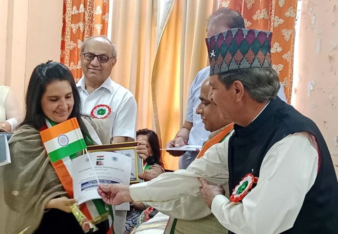 Shivani Joshi, Principal Lawrence Public School Jammu receiving award in a function held at Jammu on Wednesday.