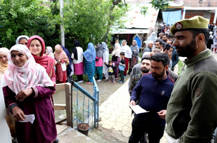 People in a line waiting to cast their votes at a polling station in Rainawari area of Srinagar on Monday. — Excelsior/Shakeel