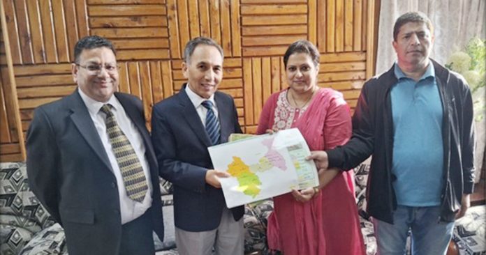 Justice Tashi Rabstan receiving detailed fact sheet from J&K Election Deptt officers.