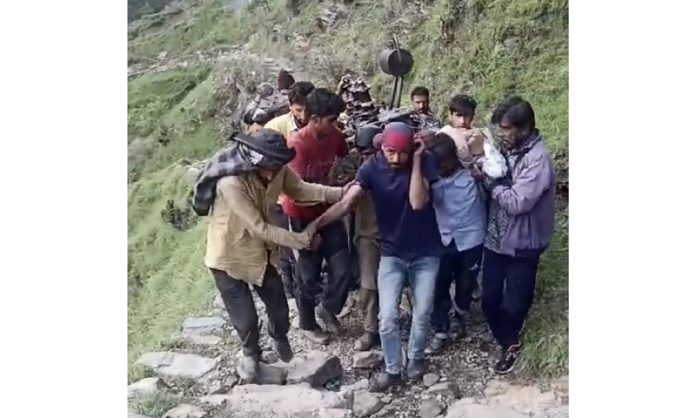 Phagwari villagers carrying PDD transformer on shoulders to road side in Mandi Tehsil of Poonch. — Excelsior/Waseem Phagwari villagers carrying PDD transformer on shoulders to road side in Mandi Tehsil of Poonch. — Excelsior/Waseem