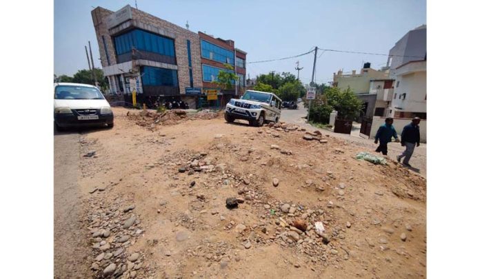 A four-wheeler navigating through the muck dumped in a hazardous manner near Sainik Colony area.