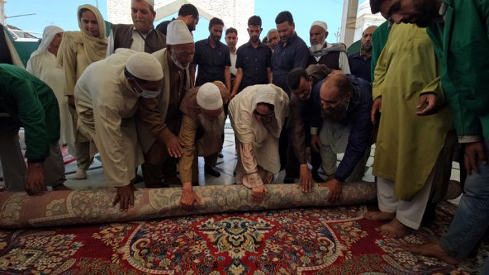 Waqf Board Chairperson, Dr. Darakhshan Andrabi spreading carpet at Hazratbal Shrine in Srinagar on Friday.