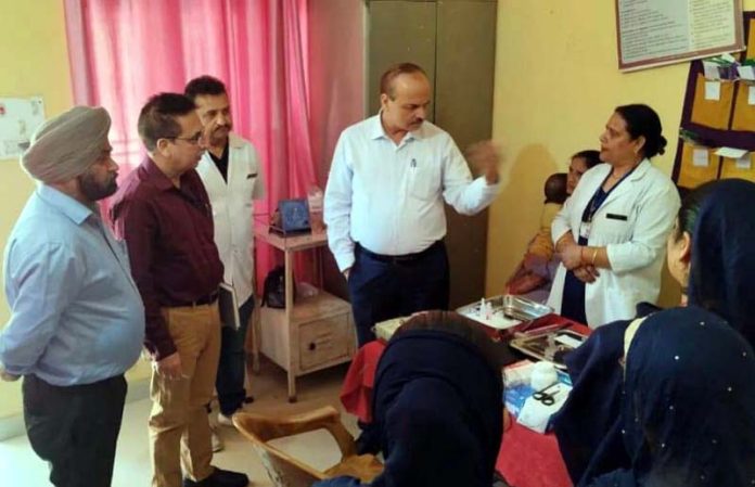 DHS Jammu Dr Rakesh Magotra interacting with staff member at NTPHC Chanderkote in Ramban district.