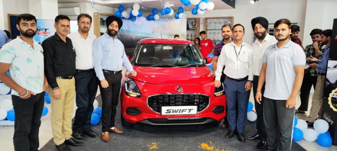 Sanjay Aggarwal, MD Jammu Motors Pvt Ltd along with others launching new Swift in Jammu on Saturday.