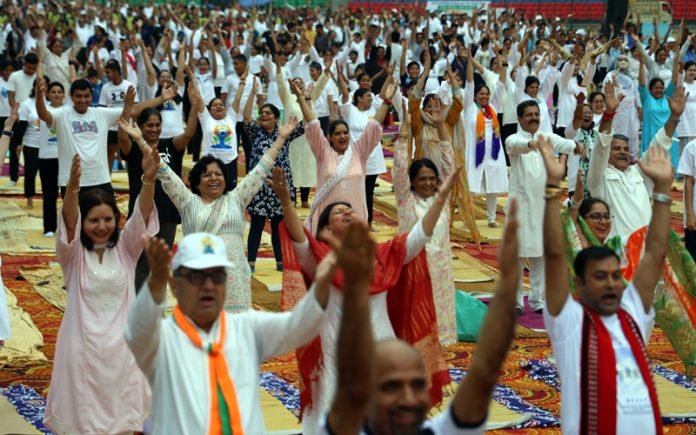 People practicing Yoga at MA Stadium in Jammu on Friday. -Excelsior/Rakesh People practicing Yoga at MA Stadium in Jammu on Friday. -Excelsior/Rakesh