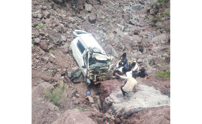 Locals trying to retrieve victims from wreckage of car. -Excelsior/Romesh Mengi Locals trying to retrieve victims from wreckage of car. -Excelsior/Romesh Mengi