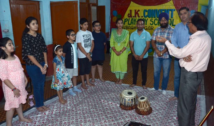 A resource person educating students about key aspects of 'Bhartiya Sangeet' during a workshop at Subhash Nagar, Jammu.