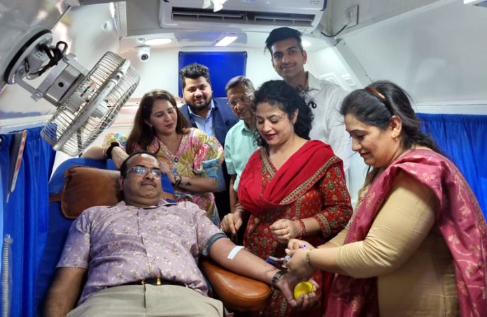 A volunteer donating blood during a camp in Jammu on Wednesday.
