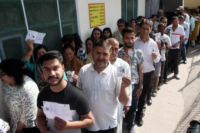 Voters displaying identity cards while standing in queue to cast their votes at a polling booth during the 7th phase of general elections in Shimla on Saturday. (UNI) Voters displaying identity cards while standing in queue to cast their votes at a polling booth during the 7th phase of general elections in Shimla on Saturday. (UNI)