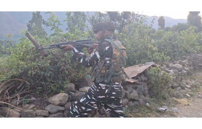 A security personnel takes position during encounter at Aragam, Bandipora on Monday. -Excelsior/Firdous