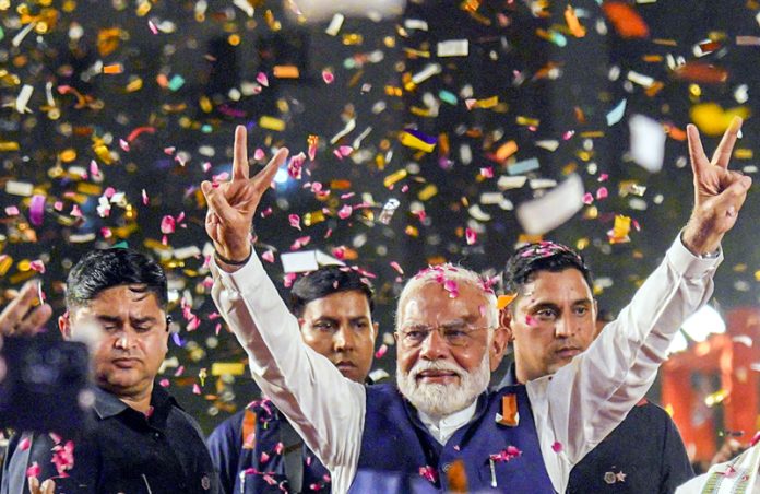 Prime Minister Narendra Modi greets supporters at BJP headquarters in New Delhi on Tuesday evening. Prime Minister Narendra Modi greets supporters at BJP headquarters in New Delhi on Tuesday evening.