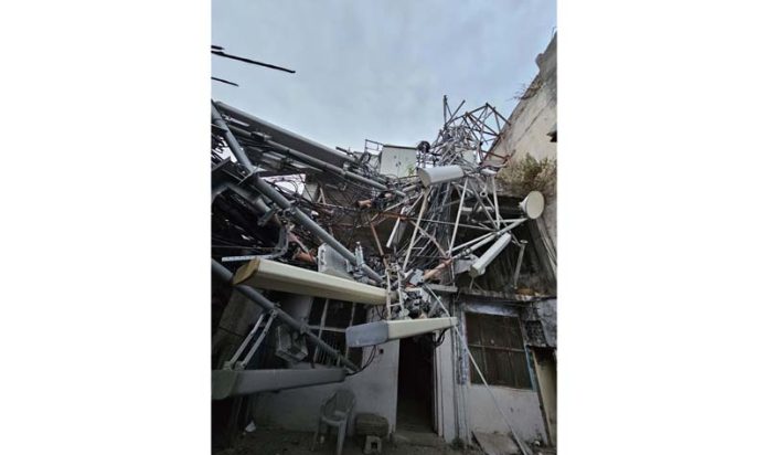 With high velocity winds, a mobile phone tower collapses near Shaheedi Chowk in Jammu on Monday. -Excelsior/Rakesh