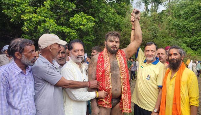 Dignitaries posing along with the winning wrestler during a Dangal event at Reasi on Friday.